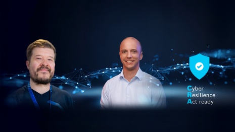 Portrait of two smiling men on a dark blue background with the text overlay: Cyber Resilience Act ready