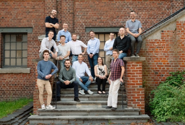 Group photo of the Arkite team, a ctrlX Automation partner, posing on the steps of a brick building.